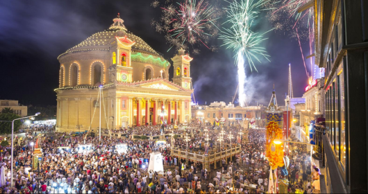 Malta village feast fireworks over a decorated parish church at night